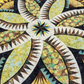 Close-up of Lily Pond Hosta quilt highlighting paper-pieced floral medallion and precision points