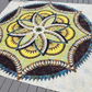 Lily Pond Hosta handmade quilt with intricate batik floral medallion laid flat outdoors.