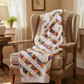 4‑Patch Charm quilt draped on a wooden bench indoors, displaying colorful patchwork fabric, quilting texture, and cozy scale.