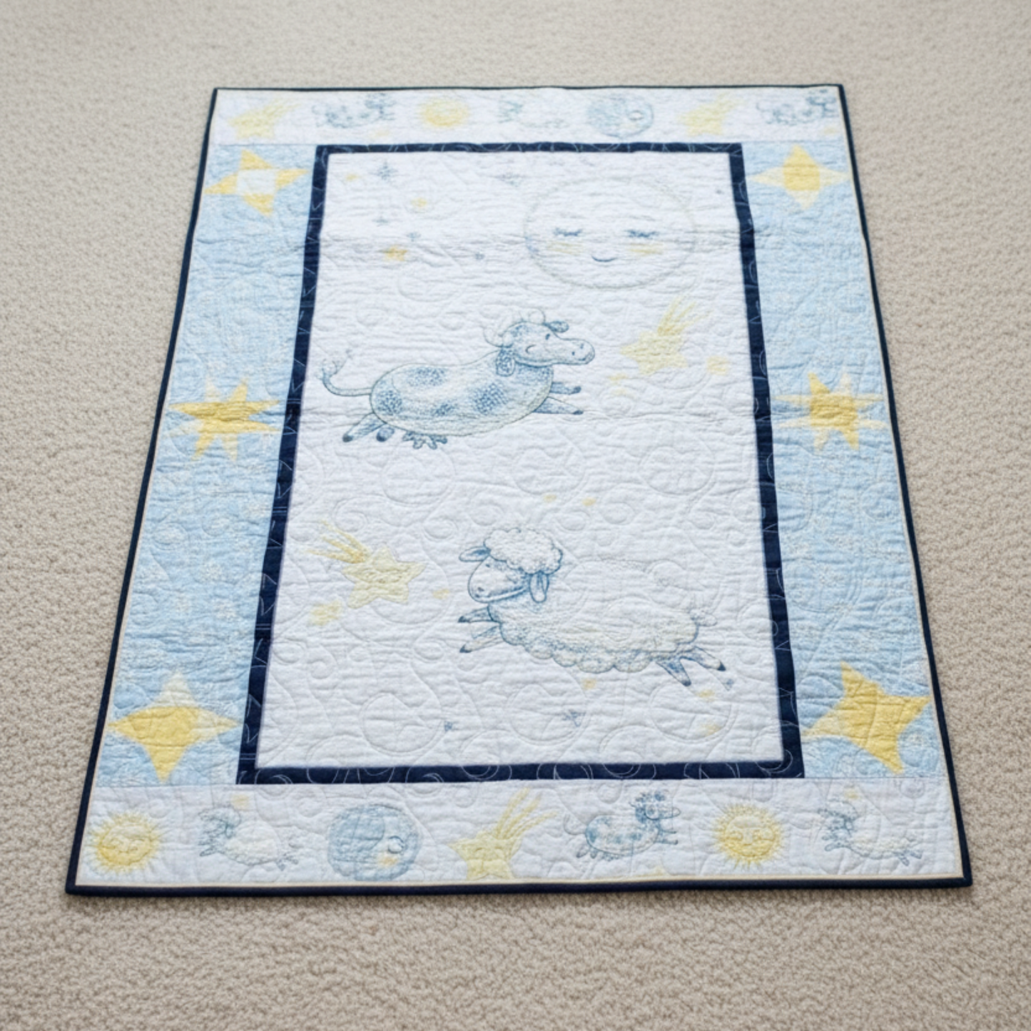 Children's quilt with space-themed design on a beige carpet