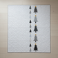 Modern handmade winter quilt with gray and black tree motifs and gold stars on a white background, 56 x 67 inches