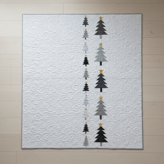 Modern handmade winter quilt with gray and black tree motifs and gold stars on a white background, 56 x 67 inches