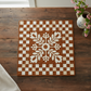 Decorative quilt with a floral pattern on a wooden table