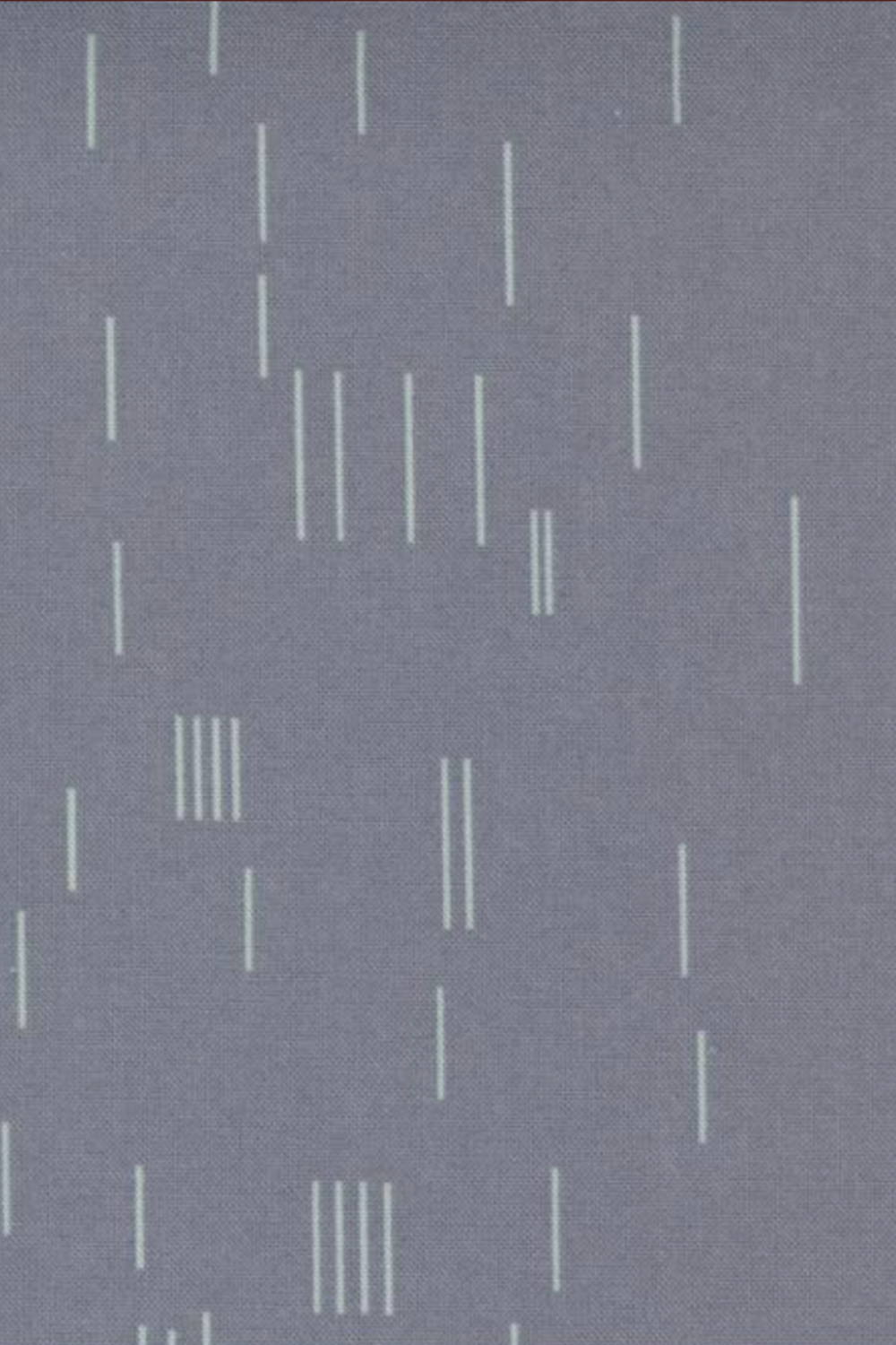 Close-up of Celestial Strokes Aluminum fabric by Zen Chic for Moda Fabrics, with scattered fine white vertical marks on gray.