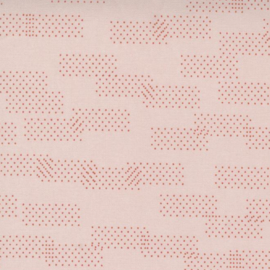 Close-up of Celestial Washi Rose Quartz fabric by Zen Chic for Moda Fabrics, featuring scattered dotted geometric marks on a blush-pink background.