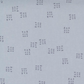 Close-up of Celestial Nine Triangle Stardust fabric by Zen Chic for Moda Fabrics, with small charcoal nine-triangle clusters on pale blue-gray. ⠋
