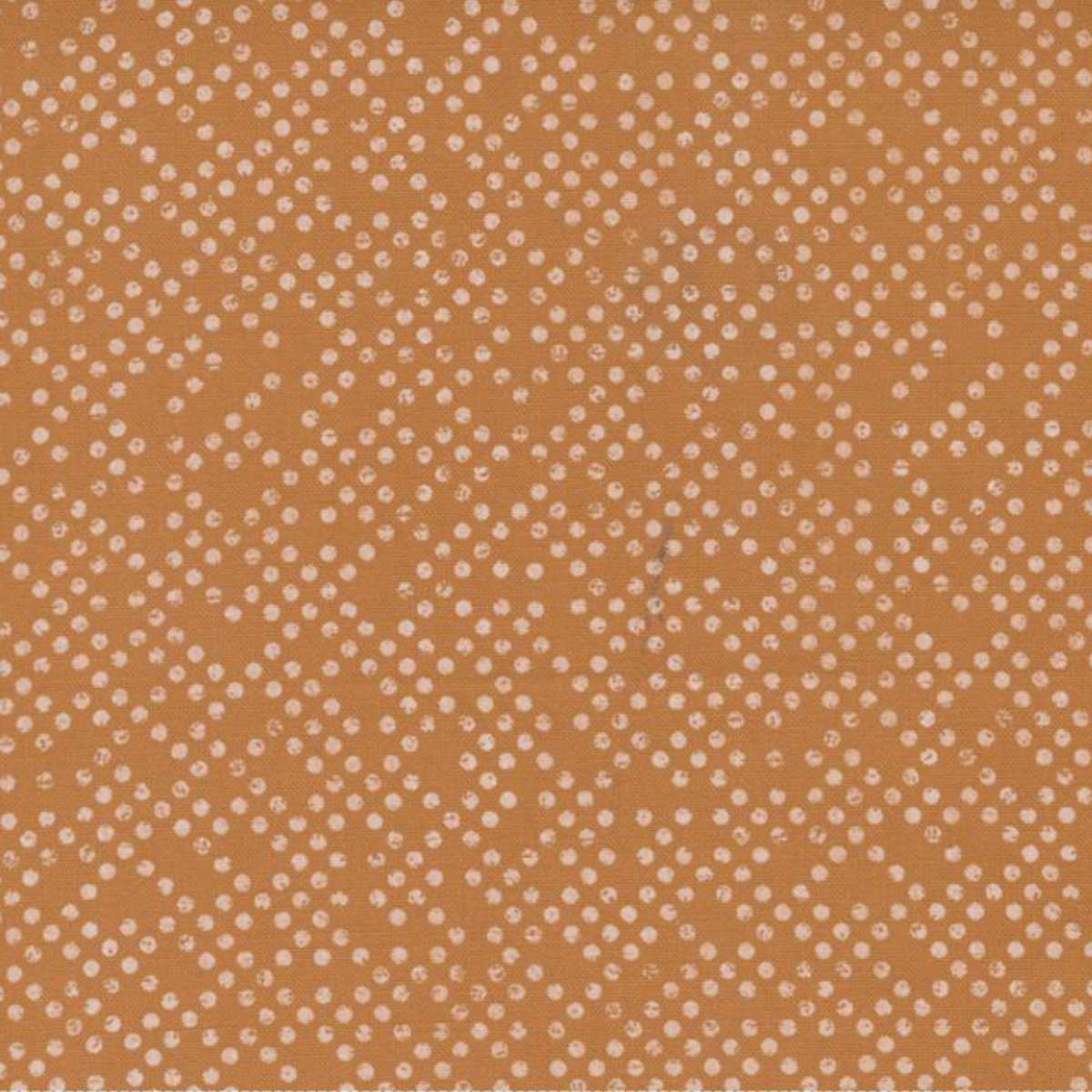 Close-up of Lazy Afternoon Bronze fabric by Zen Chic for Moda Fabrics, showing small, irregular pale dots across a warm bronze ground.