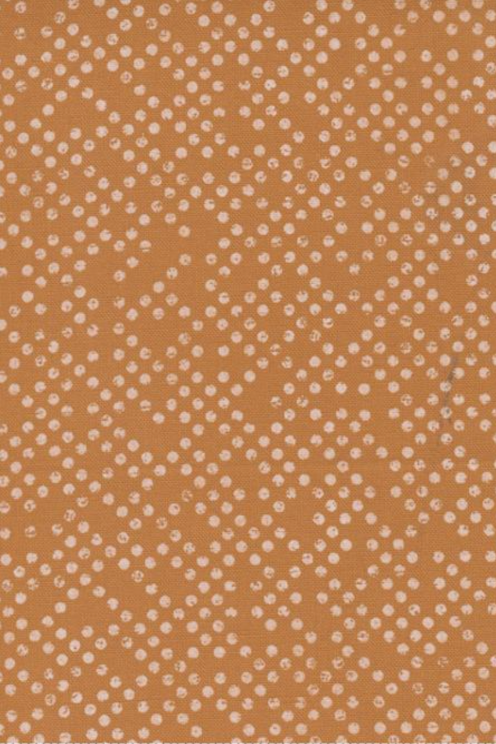 Close-up of Lazy Afternoon Bronze fabric by Zen Chic for Moda Fabrics, showing small, irregular pale dots across a warm bronze ground.