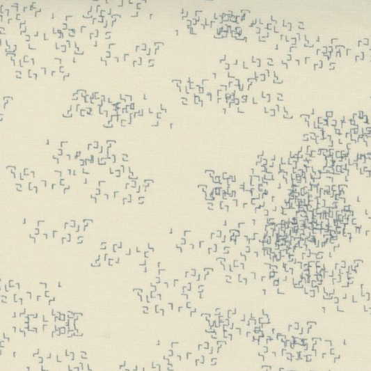 Close-up of Eggshell Edgy fabric by Zen Chic for Moda Fabrics, showing loose clusters of tiny gray angular marks on eggshell. ⠋