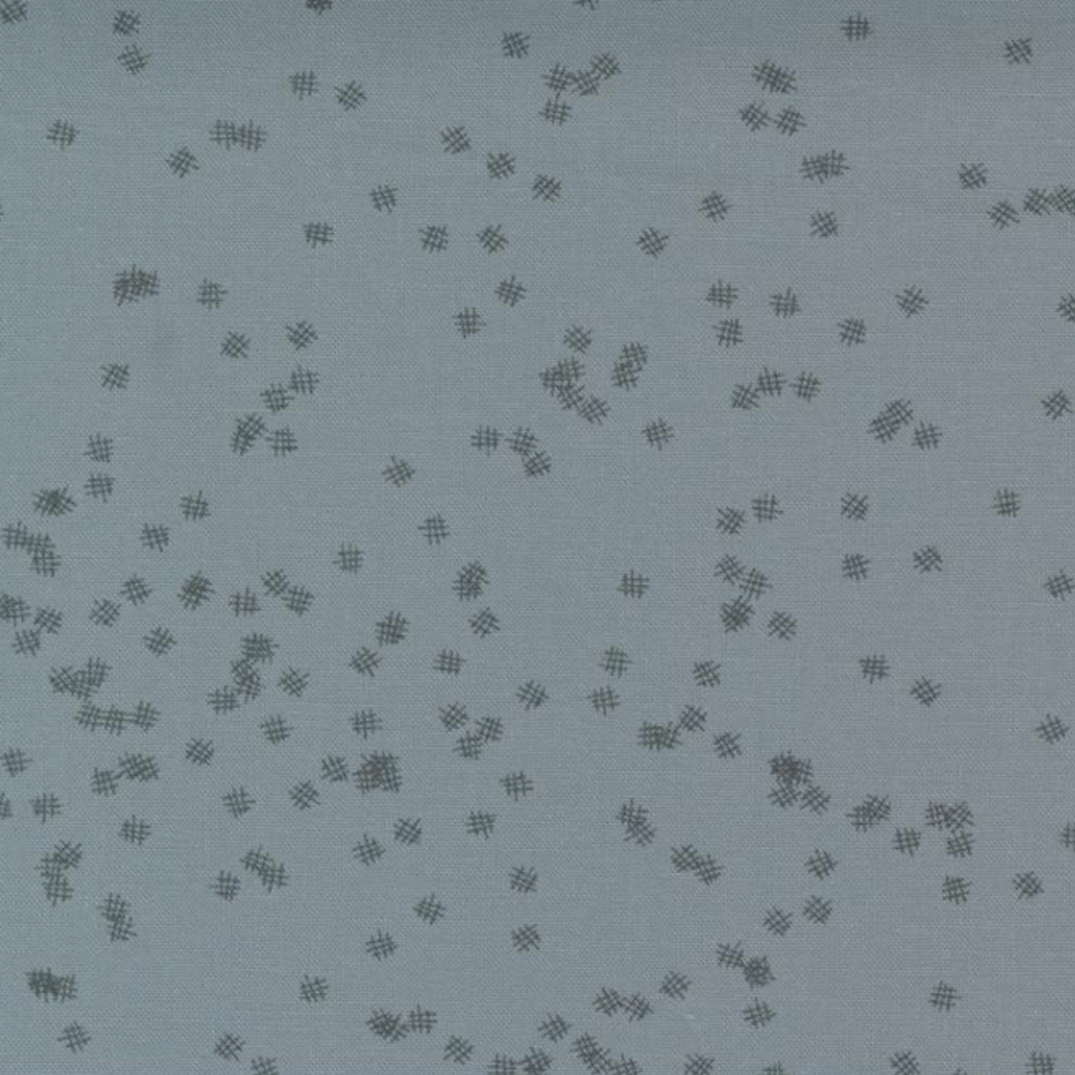 Close-up of Modern Background Even More Paper Steel Crosshatch Bolt B fabric by Zen Chic for Moda Fabrics, with scattered dark crosshatch marks on a muted steel blue-gray background.