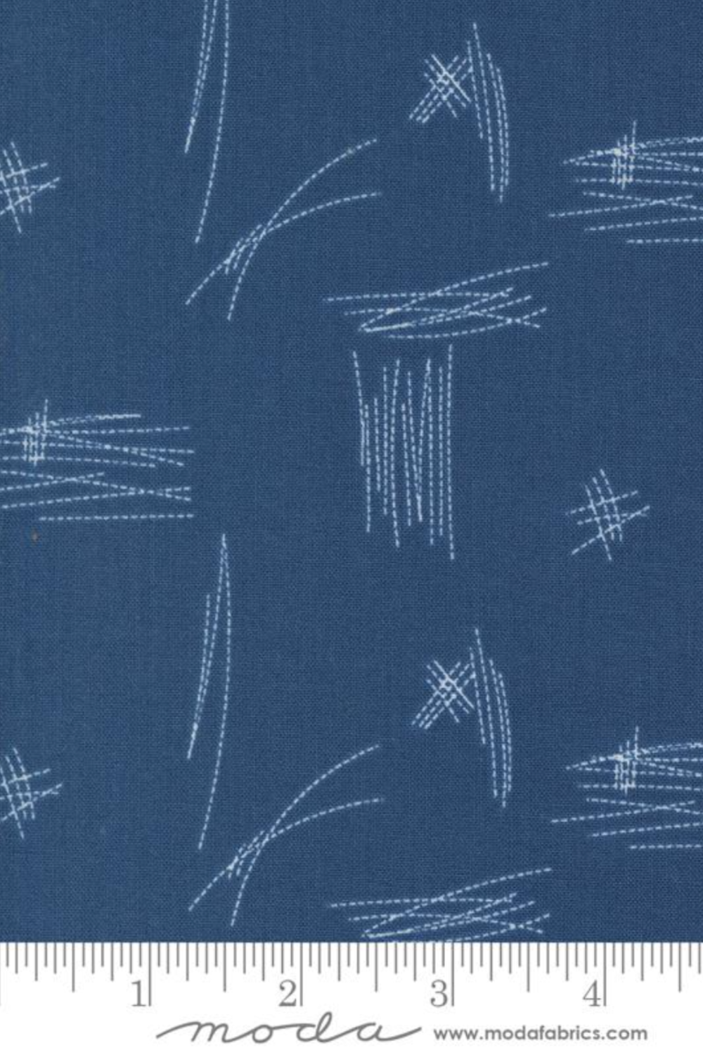 Bluish Stitched Up Blueprint quilting cotton beside a ruler, showing the scale of the pale stitched-line pattern.