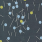 Vertical detail of Bluish Pins & Buttons Charcoal fabric by Zen Chic, showing the modern sewing-pin print and charcoal ground.