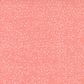Dotty Thatched Carnation quilting cotton by Robin Pickens for Moda Fabrics — close-up showing the warm coral-pink ground with scattered tonal dots and crosshatch texture detail. 100% cotton. Available at IraRobi Quilts.