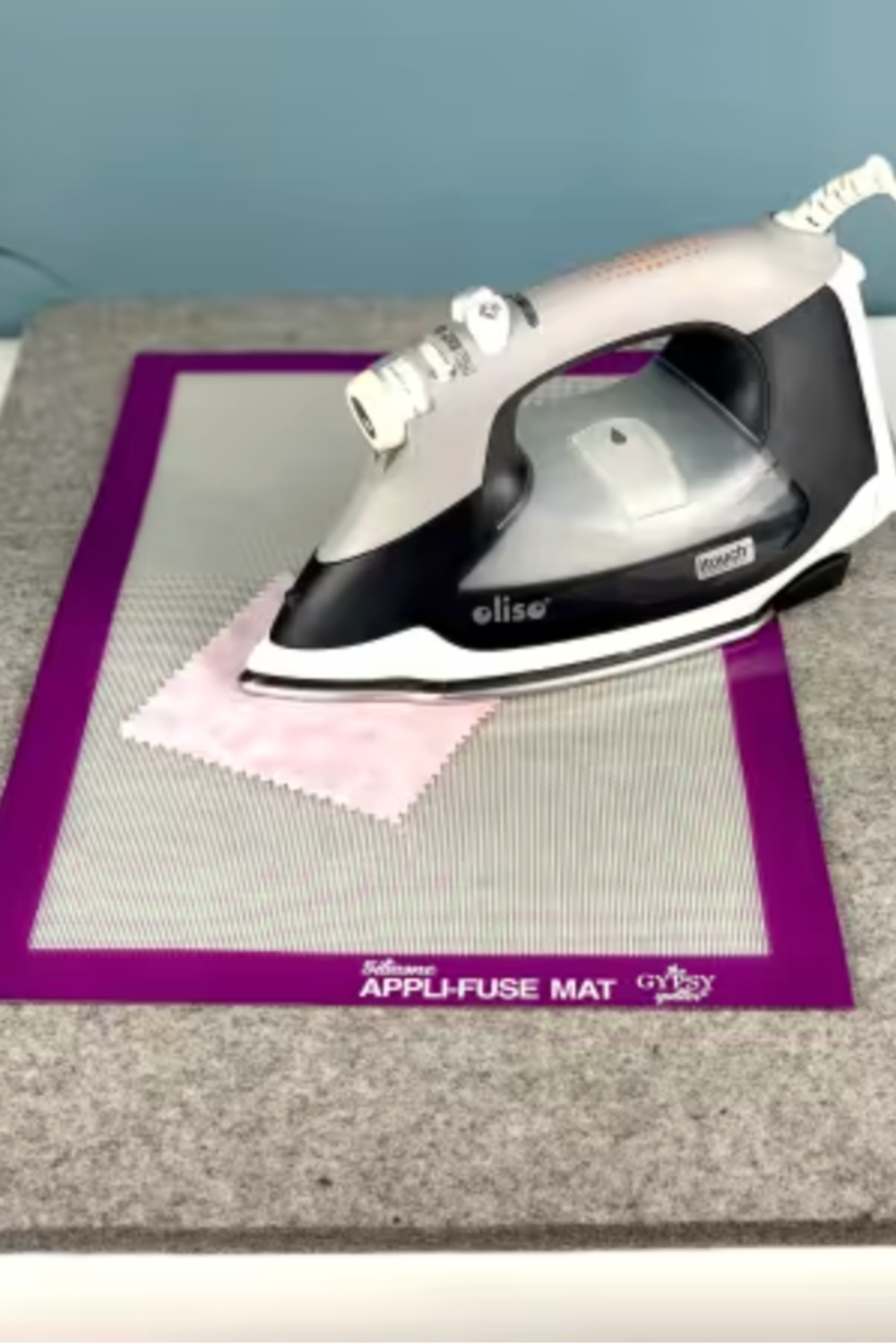 Iron lifting from fused appliqué design on Silicone Appli-Fuse Mat after pressing on the wool pressing mat.