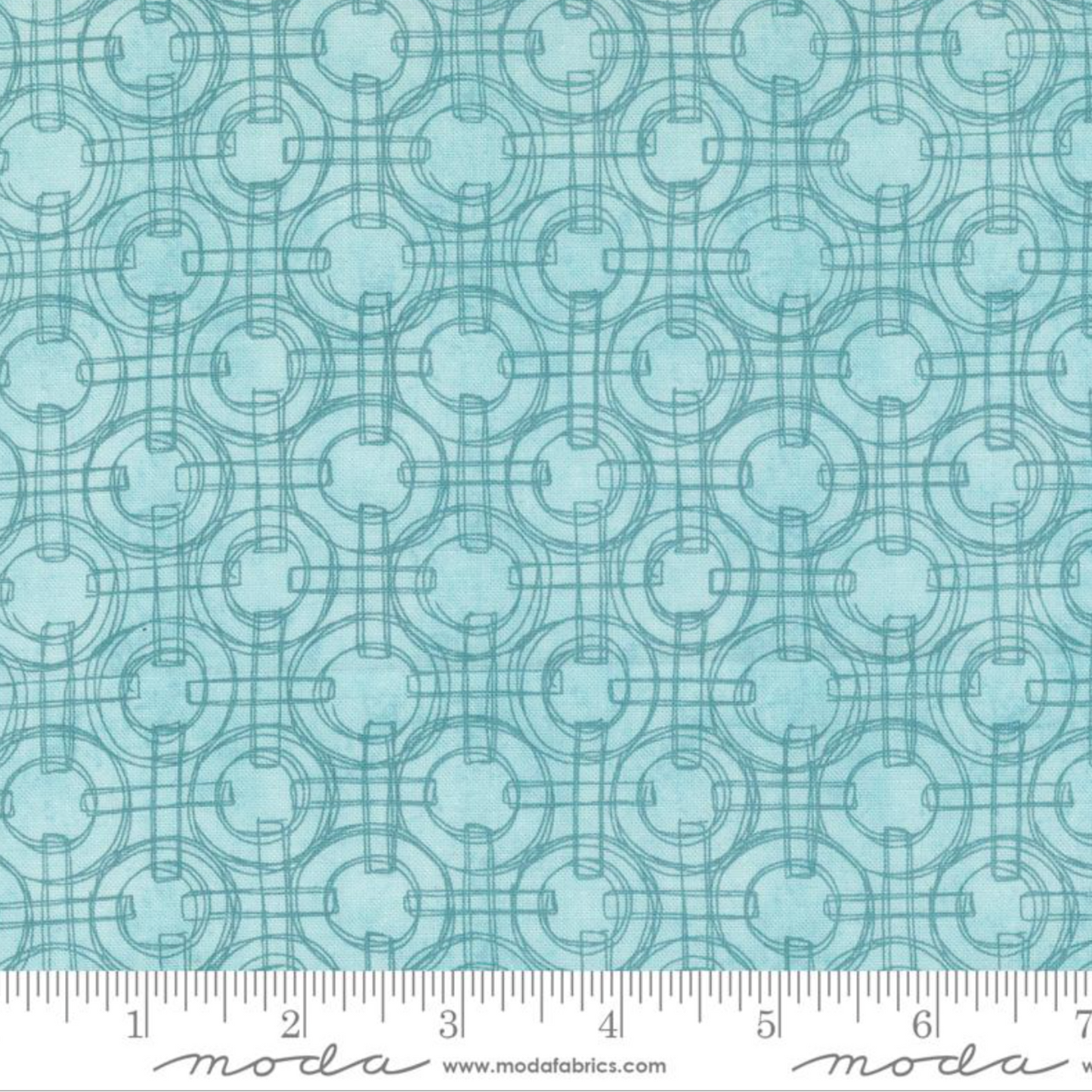 Teal fabric pattern with a ruler at the bottom for scale, featuring the Moda Fabrics logo.