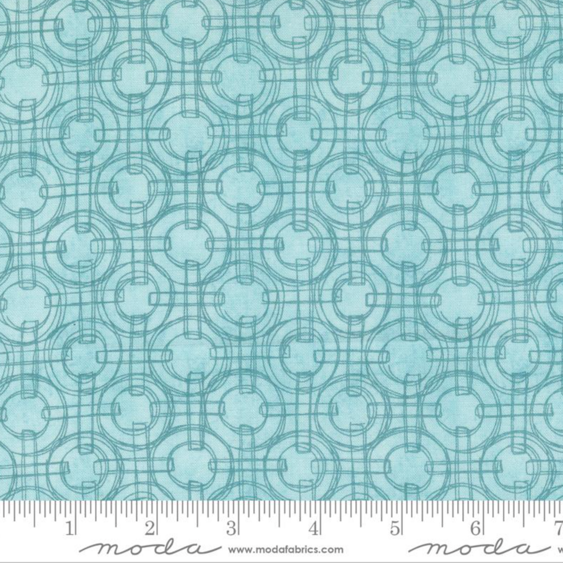 Teal fabric pattern with a ruler at the bottom for scale, featuring the Moda Fabrics logo.