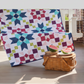 Barn star sampler quilt – star quilt displayed on porch with picnic basket and watermelon