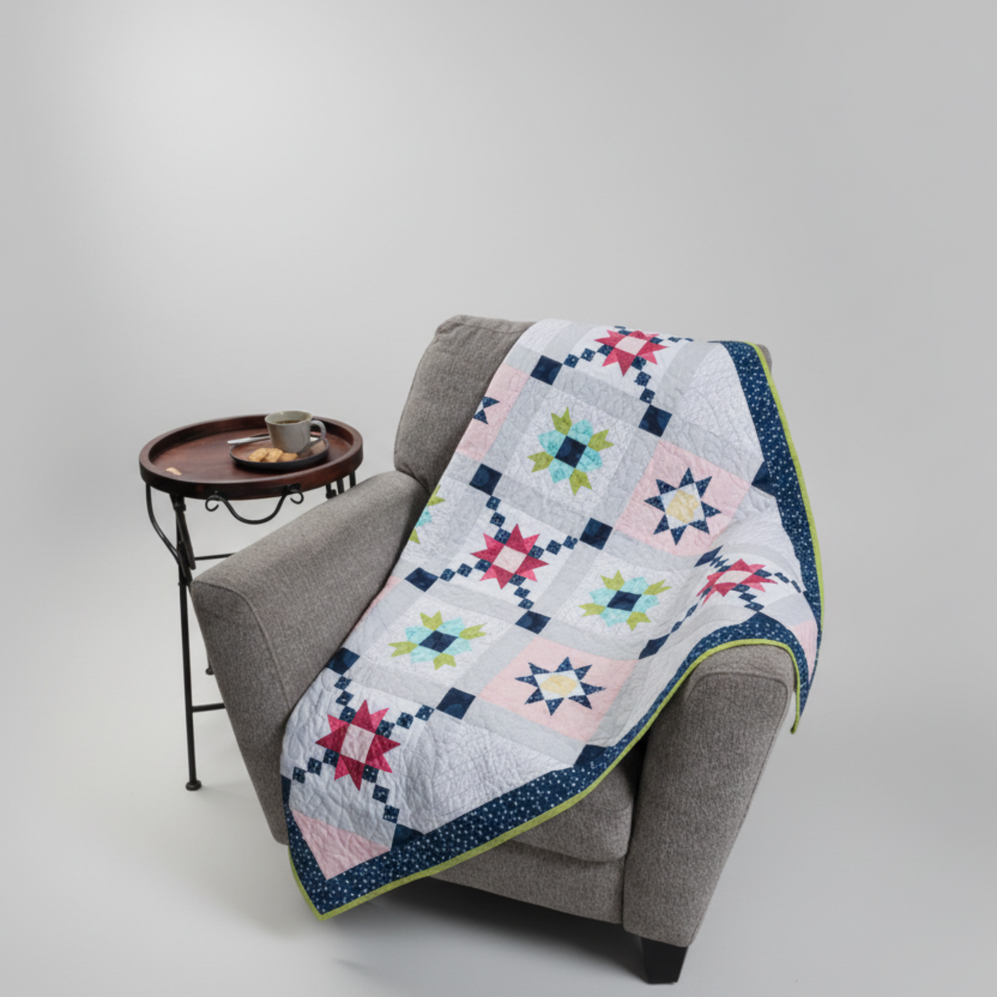Barn star quilt throw – sampler quilt draped over chair in modern home setting