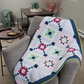 Barn star quilt throw – sampler quilt draped over chair in modern home setting