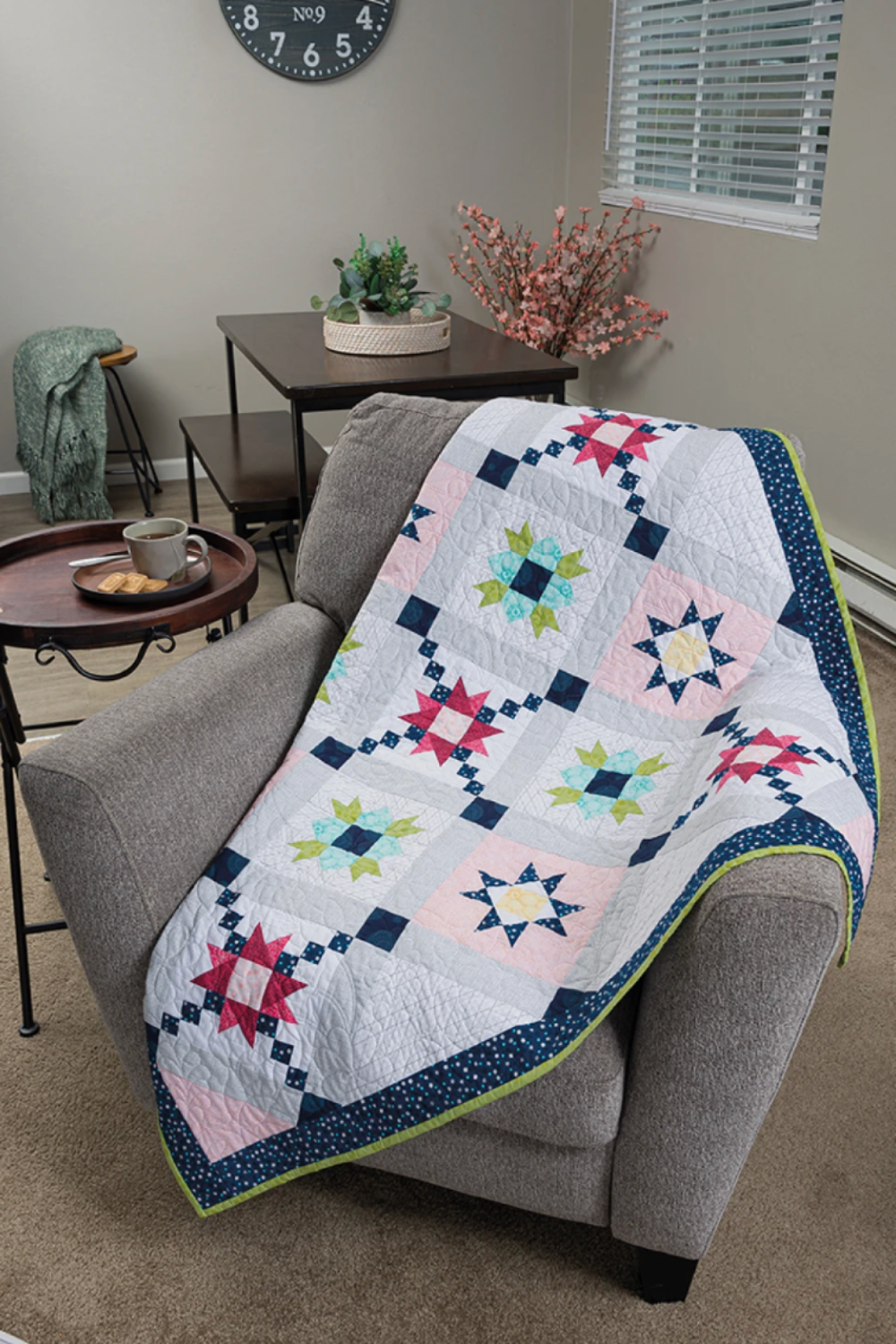 Barn star quilt throw – sampler quilt draped over chair in modern home setting