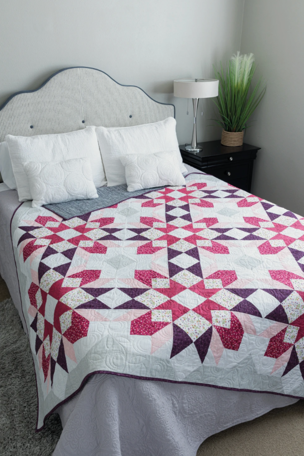 Barn star quilt bed design – pink and purple star sampler quilt on bed
