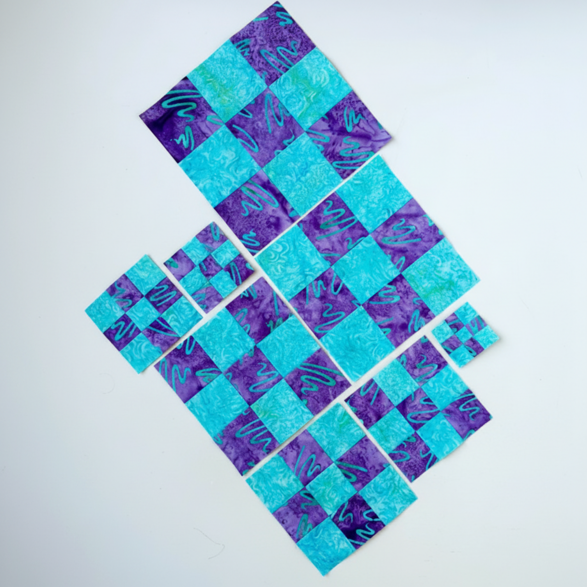 Blue and purple checkered fabric pattern on a white background