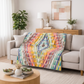 Modern quilt – Tripping Out – colorful geometric quilt draped on sofa in living room
