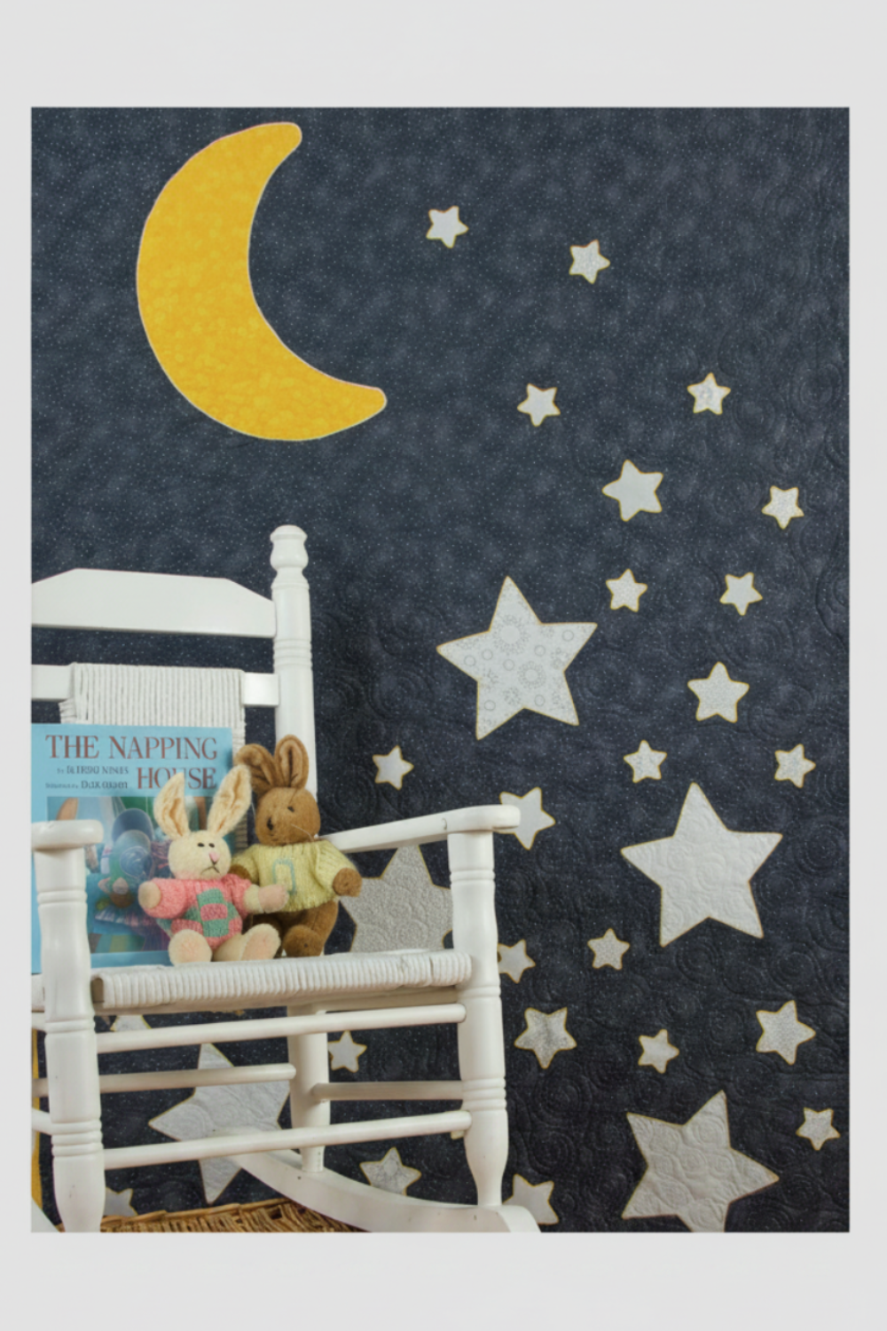 Moon and Stars nursery quilt wall hanging with yellow crescent moon and white stars on dark navy background