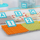 Close-up of AlphaClippies specialty marking clips labeling colorful quilting fabric squares with letters and numbers