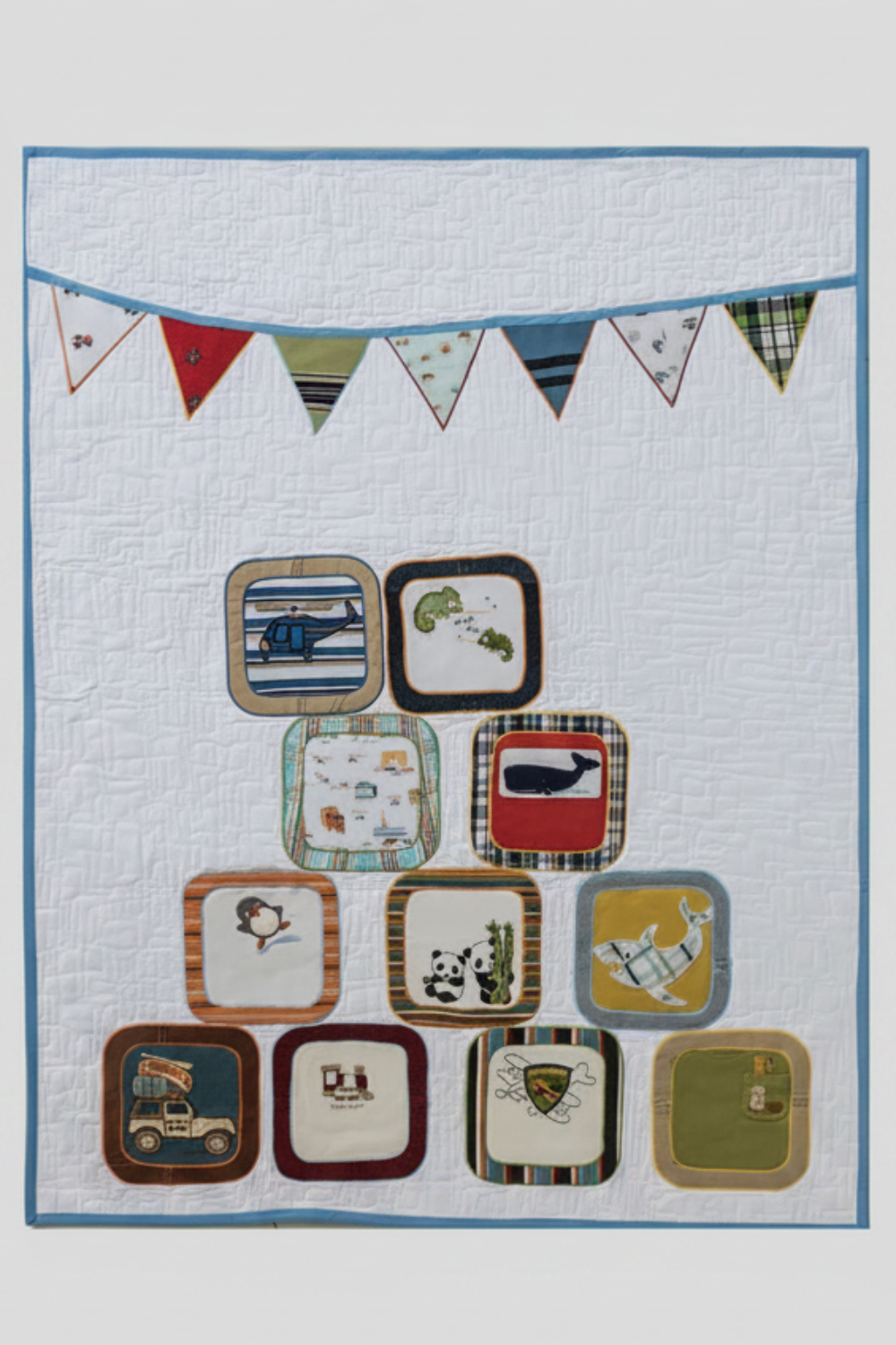 T-shirt quilt project made with children’s clothing and colorful appliqué banner design