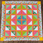 Handmade In the Jungle quilt featuring colorful jungle animals, tropical prints, coral sashing, yellow accents, and animal-print border.