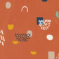 Close-up of Frisky Catch Me Cheeky fabric by Zen Chic for Moda Fabrics showing navy, mint, mustard, cream, and blush abstract shapes on a rust-orange ground