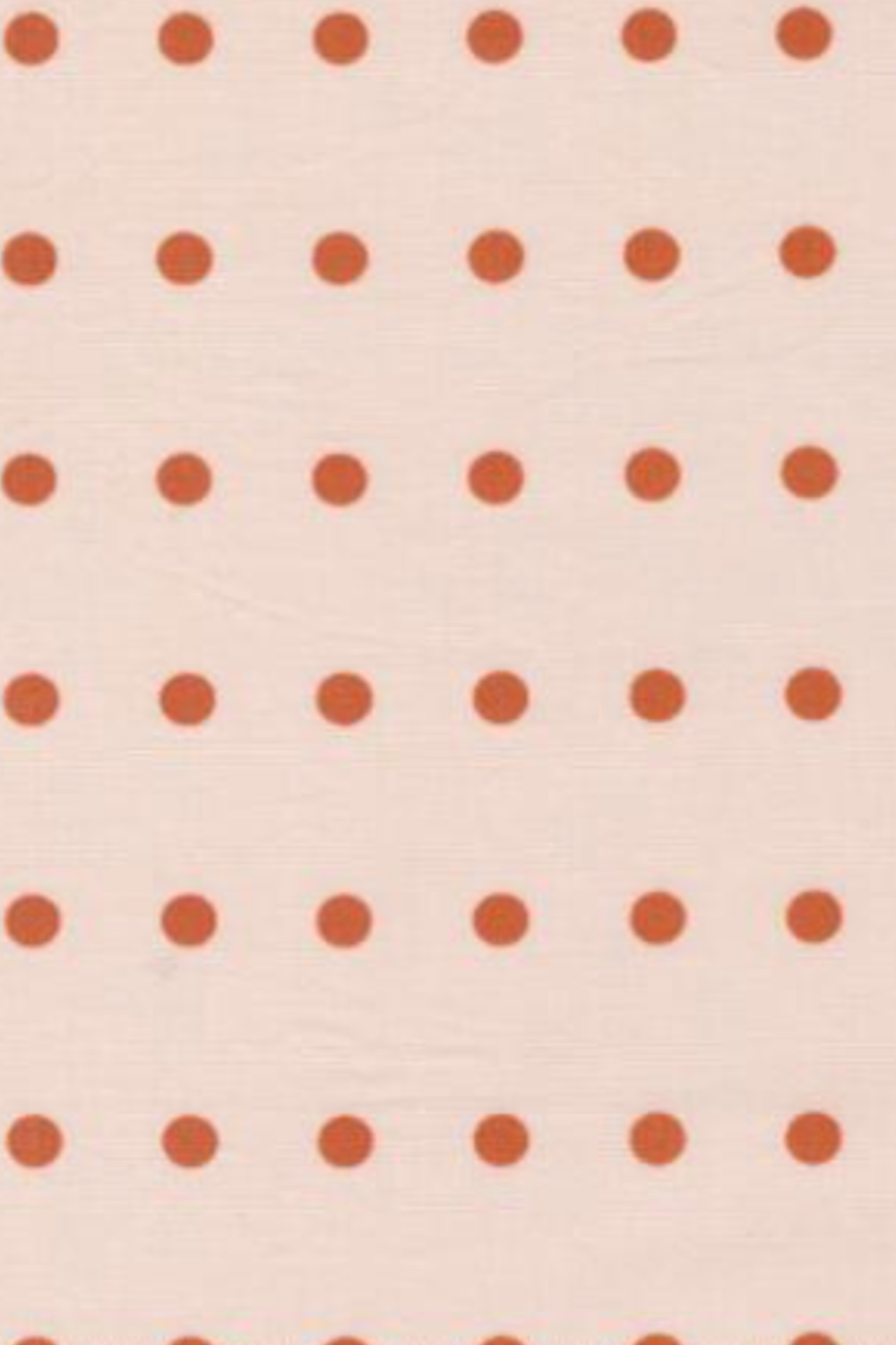Close-up of Frisky In A Row Sweetie fabric by Zen Chic for Moda Fabrics – evenly spaced rust-orange dots in neat rows on a soft blush-pink cotton ground. Available at IraRobi Quilts.