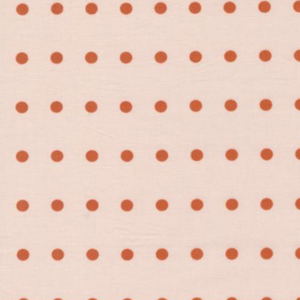 lose-up of Frisky In A Row Sweetie fabric by Zen Chic for Moda Fabrics showing rust-orange dots in neat rows on blush pink