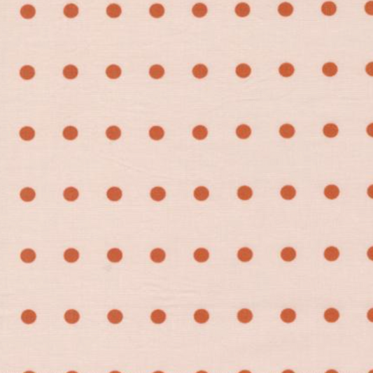 lose-up of Frisky In A Row Sweetie fabric by Zen Chic for Moda Fabrics showing rust-orange dots in neat rows on blush pink