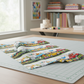 Close-up detail of On the Go Multi Border Stripe quilting cotton fabric highlighting whimsical animals and vehicles