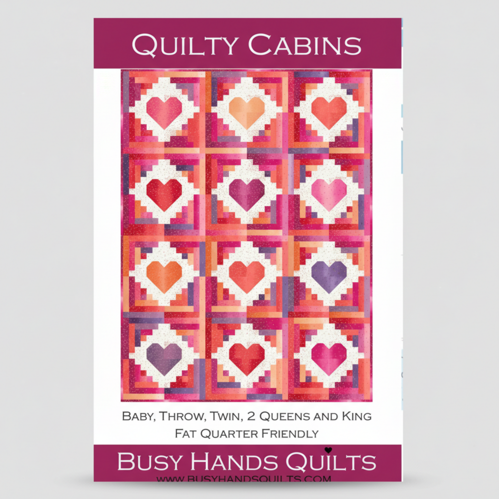 Quilt pattern cover with heart design and 'Quilty Cabins' branding