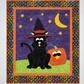 Halloween-themed quilt with a black cat in a witch hat and a pumpkin on a colorful border.