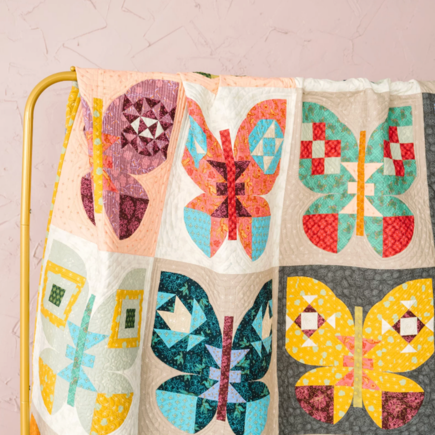 Quilt with colorful butterfly patterns on a light background