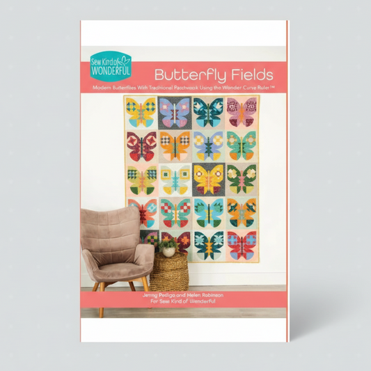 Pattern book cover for 'Butterfly Fields' with a quilt design and chair in the background.