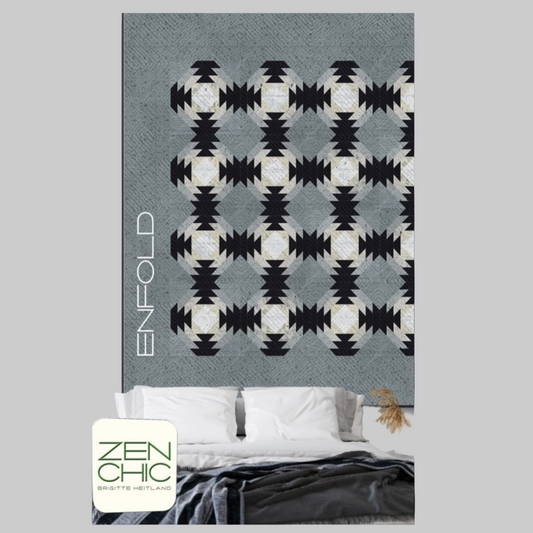 Patterned blanket with 'Enfold' branding on a bed in a bedroom setting.