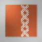 Decorative quilt with geometric pattern on an orange background