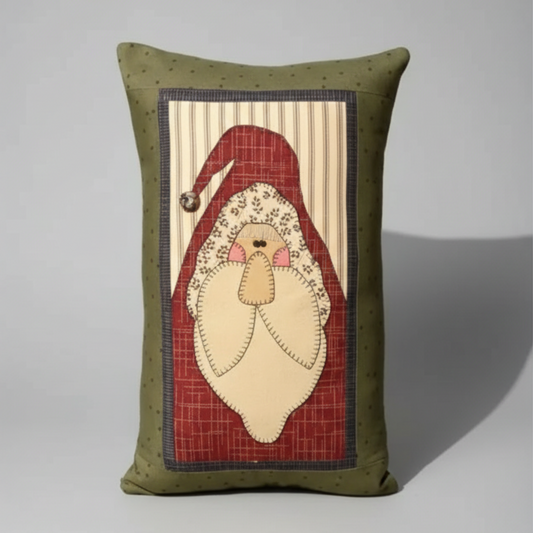 Decorative pillow with a Santa Claus design on a wooden surface.