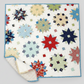 Colorful star-shaped patchwork quilt on a white background