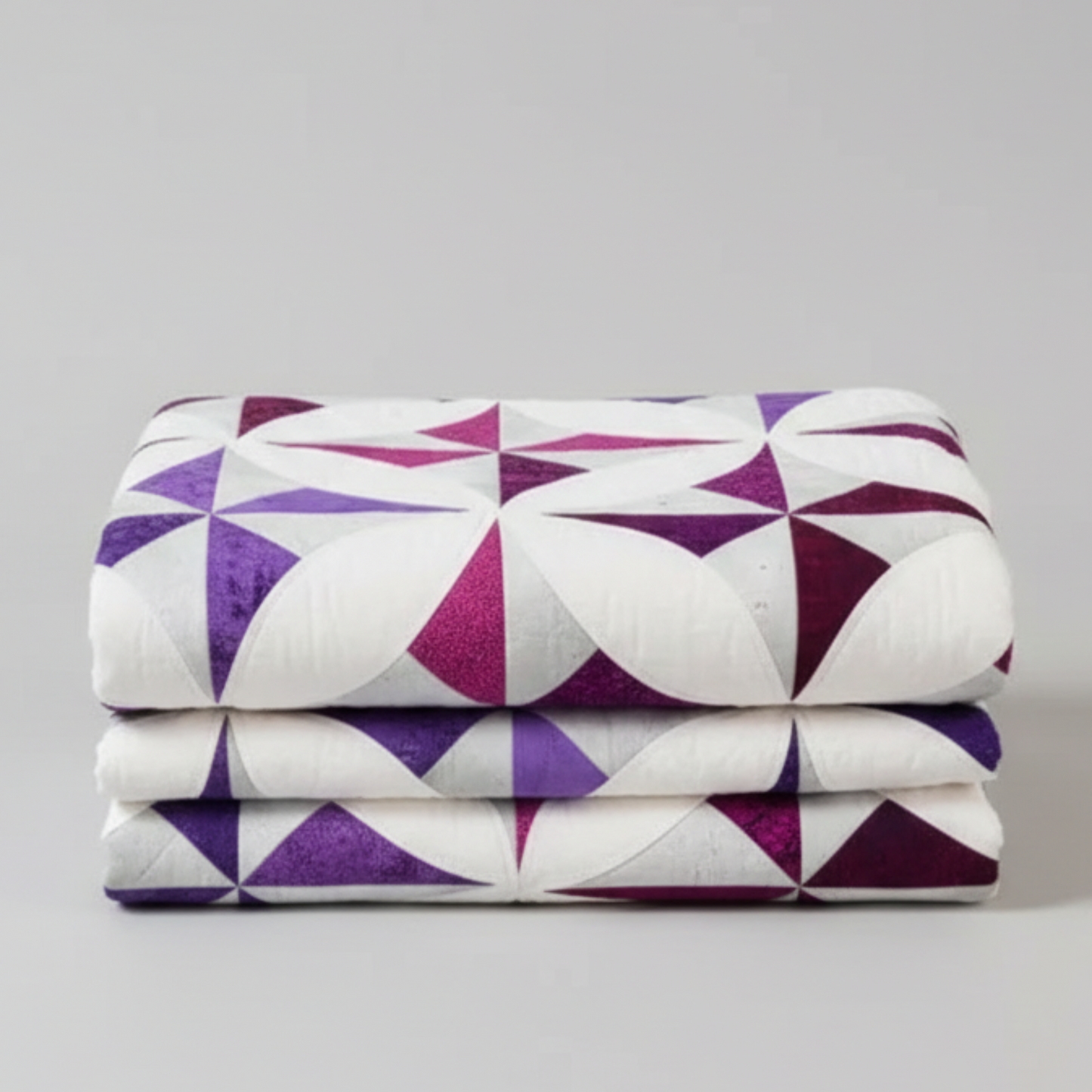 Quilt with purple and white star pattern draped over a chair, Shabby Fabrics logo visible