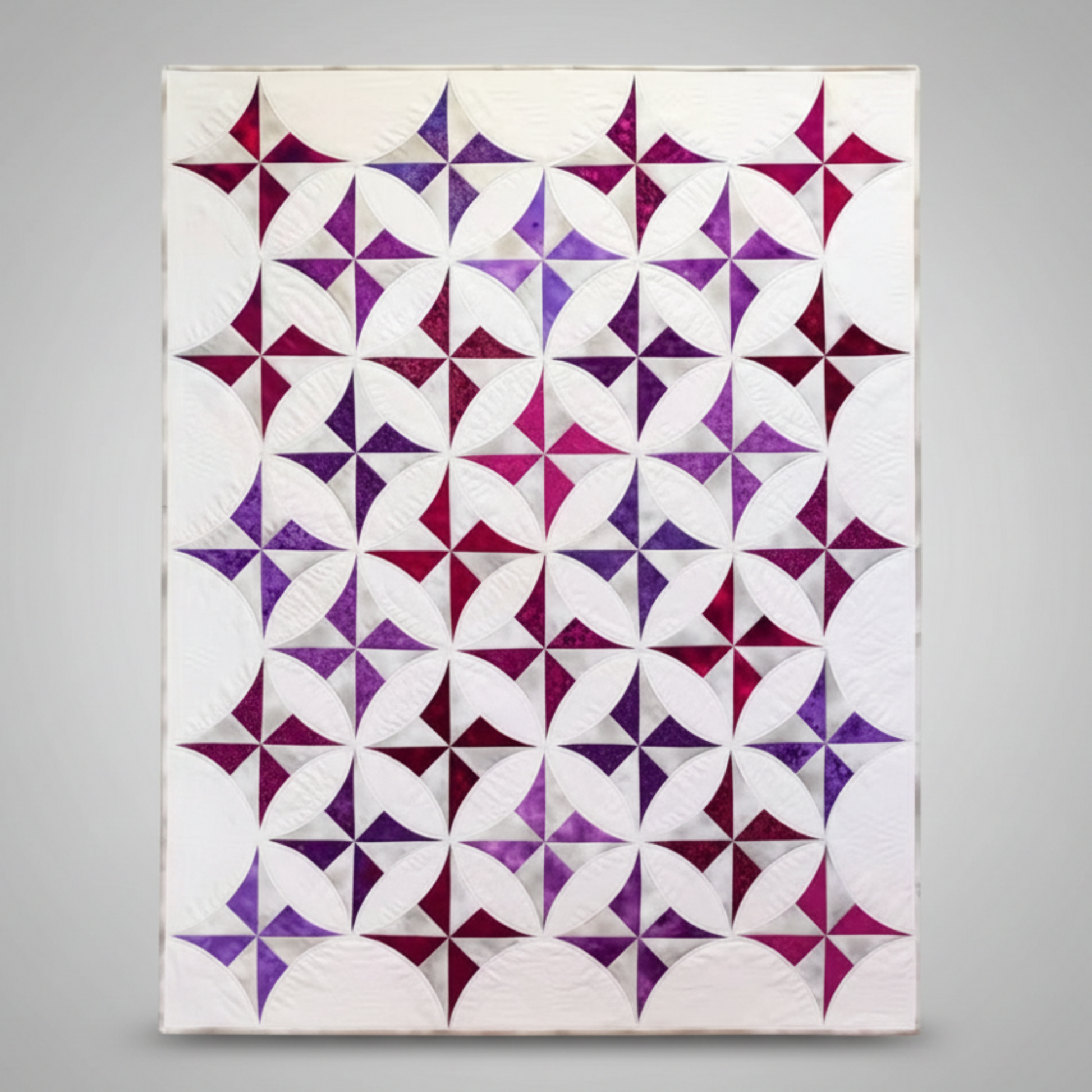 Quilt with purple and white star pattern on a white background