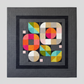 Colorful geometric quilt pattern framed against a gray background