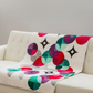 Decorative blanket with colorful circular pattern on a sofa
