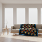 Decorative quilt with geometric pattern draped over a sofa in a modern living room.