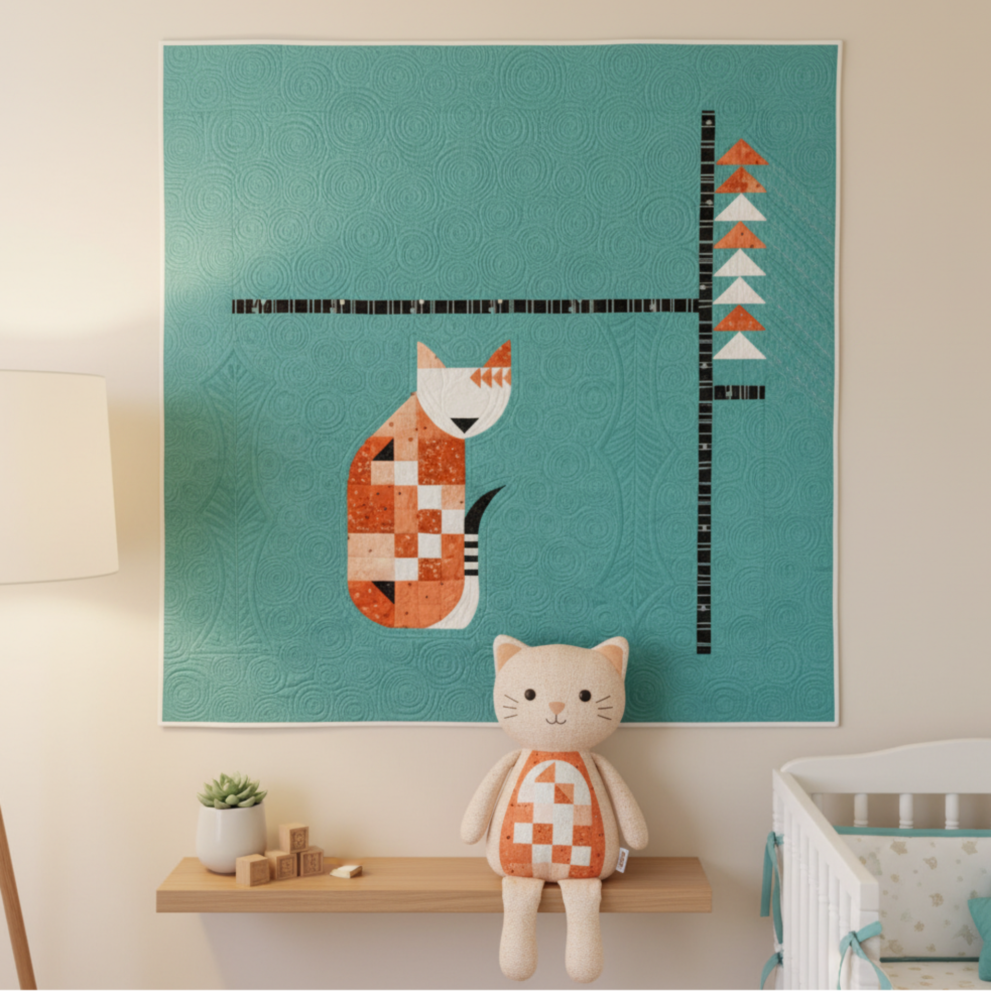 Quilt with a cat design on a teal background